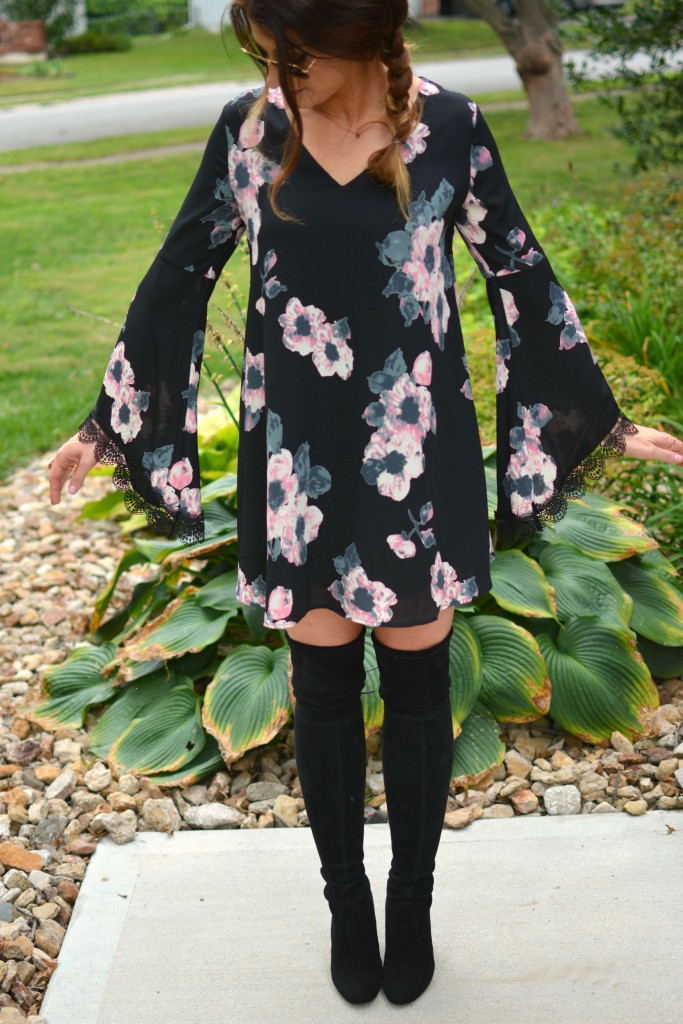 Ashley from LSR in a floral dress and Stuart Weitzman Highland boots