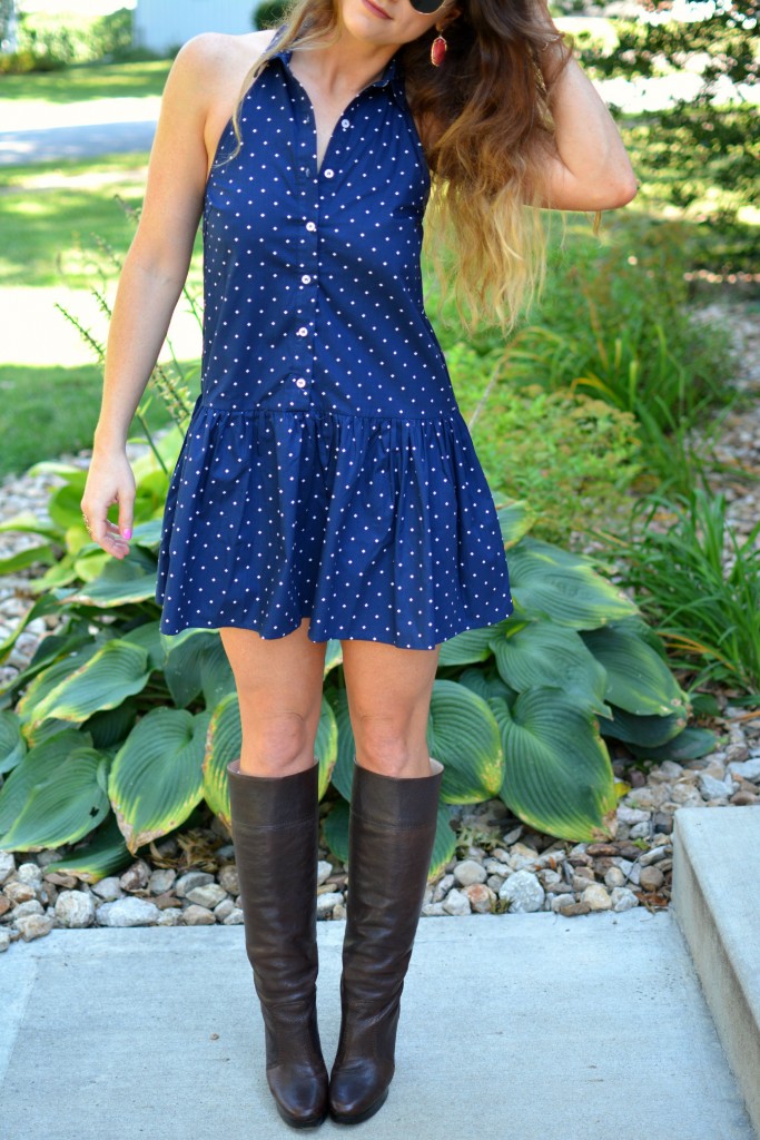 ashley from lsr in a navy polka dot dress, kendra scott elle earrings and jana bracelet, and michael kors boots