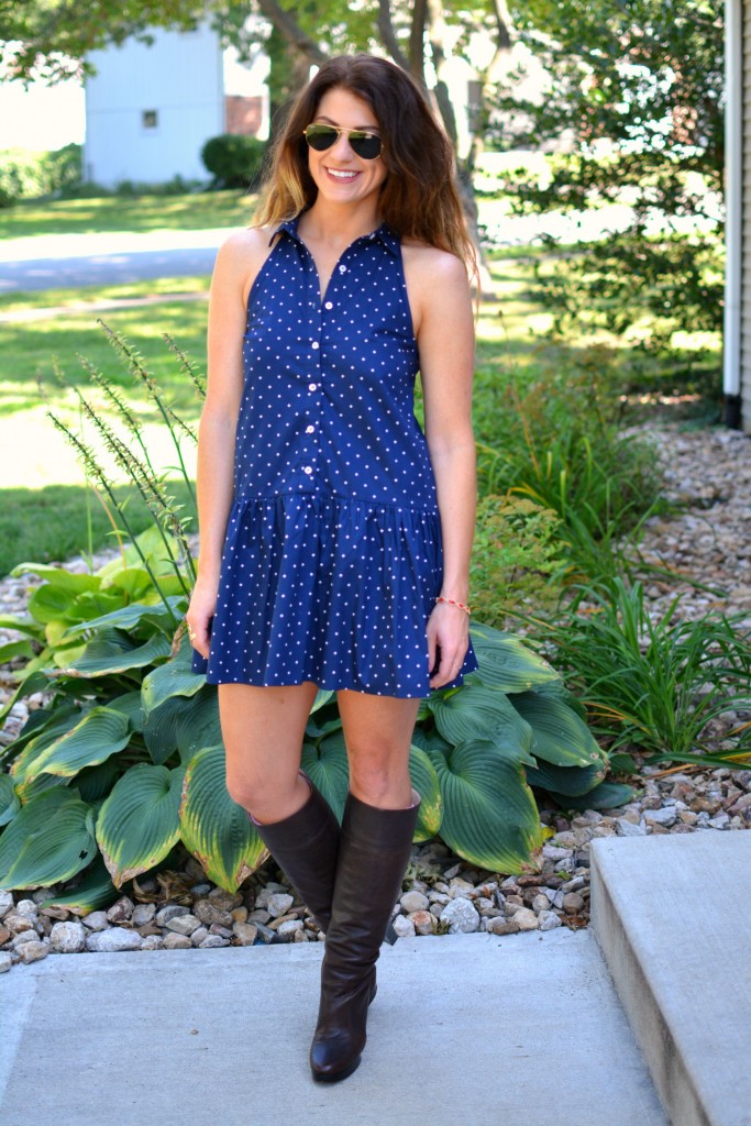 ashley from lsr in a navy polka dot dress, kendra scott elle earrings and jana bracelet, and michael kors boots