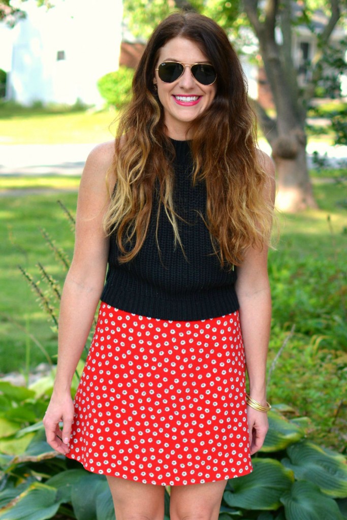 ashley from lsr in a black cropped sweater and daisy skirt