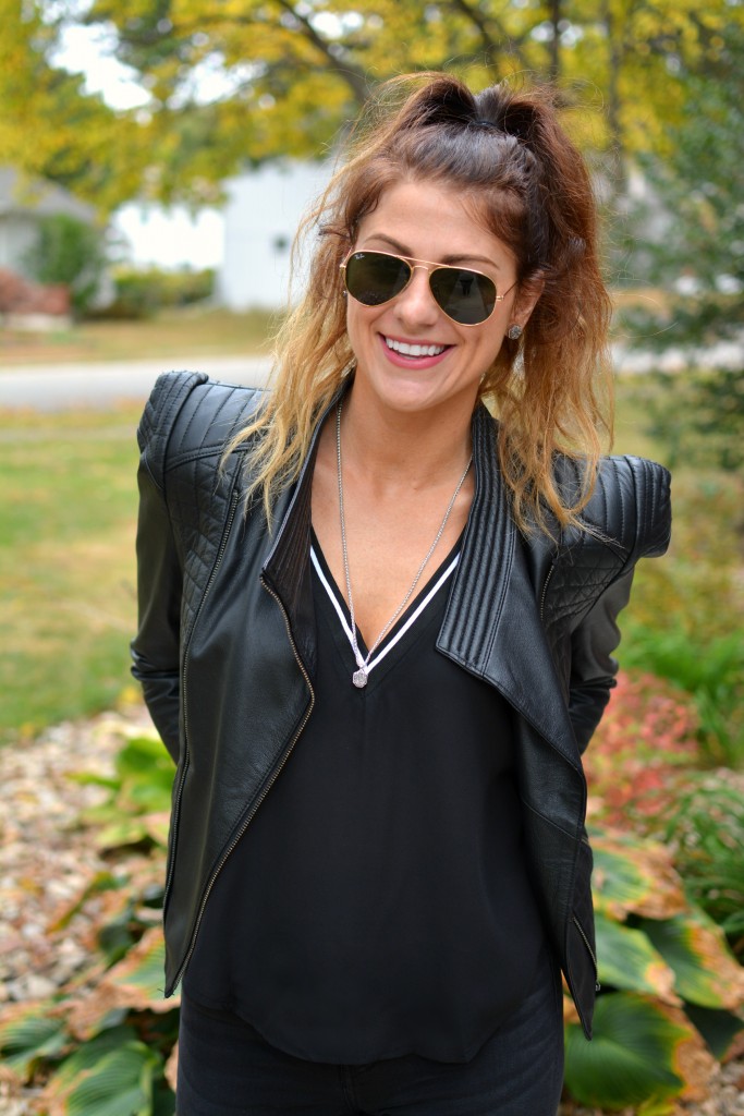 Ashley from LSR in a black leather jacket and Kendra Scott earrings and necklace.