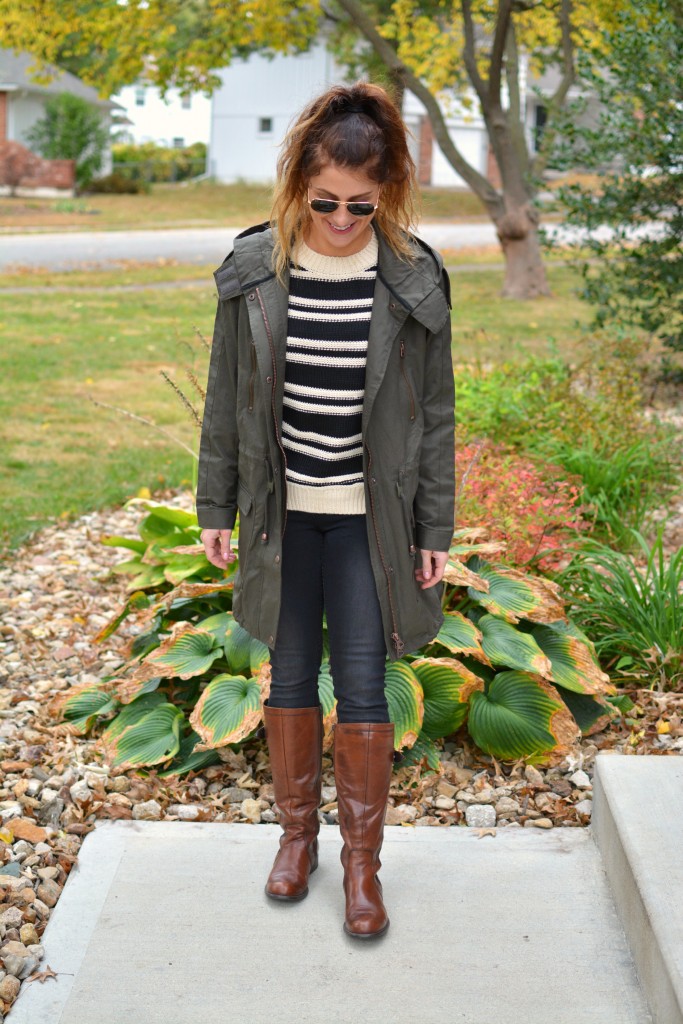 Ashley from LSR in a lightweight parka (glastonbury coat), black denim, and riding boots.