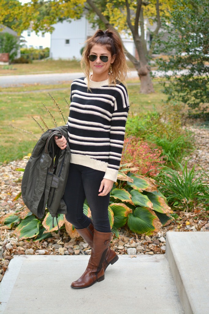 Ashley from LSR in a striped H&M sweater and black jeans, with riding boots.