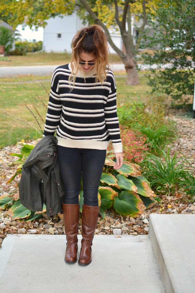 Ashley from LSR in a striped H&M sweater and black jeans, with riding boots.