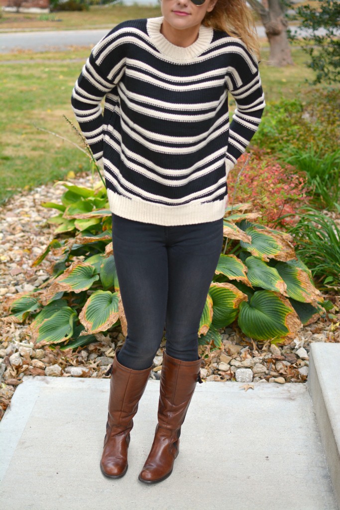 Ashley from LSR in a striped H&M sweater and black jeans, with riding boots.