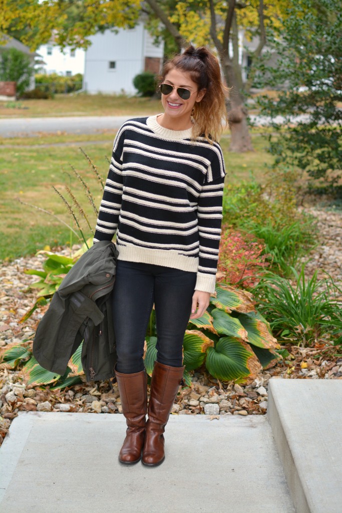 Ashley from LSR in a striped H&M sweater and black jeans, with riding boots.