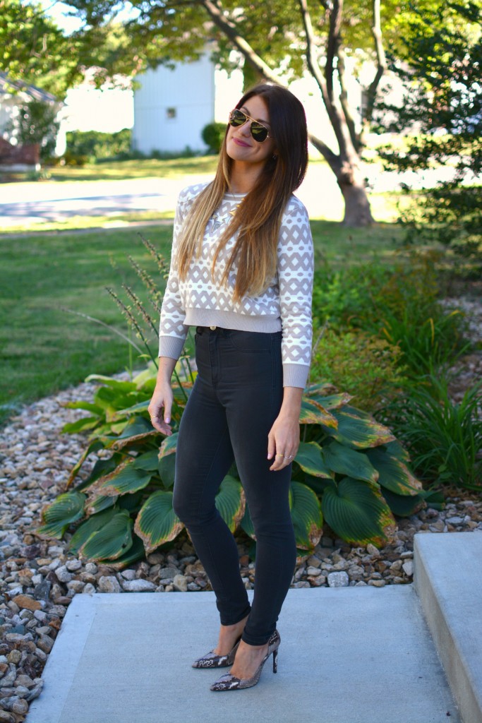 Ashley from LSR in high-waisted black H&M jeggings, cropped printed sweater, and snake skin pumps