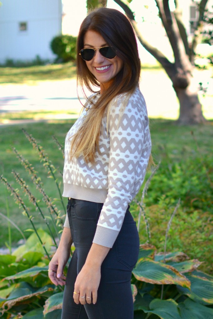 Ashley from LSR in high-waisted black H&M jeggings and a cropped printed sweater. 
