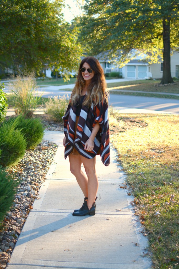 Ashley from LSR in an Old Navy poncho, tan suede skirt, and Jeffrey Campbell booties.