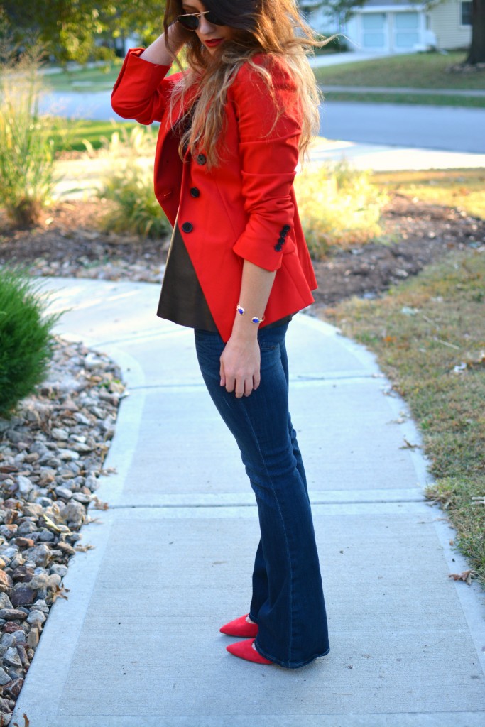 Ashley from LSR in a fire engine red blazer, flares, a leather camisole, and Kendra Scott jewelry.