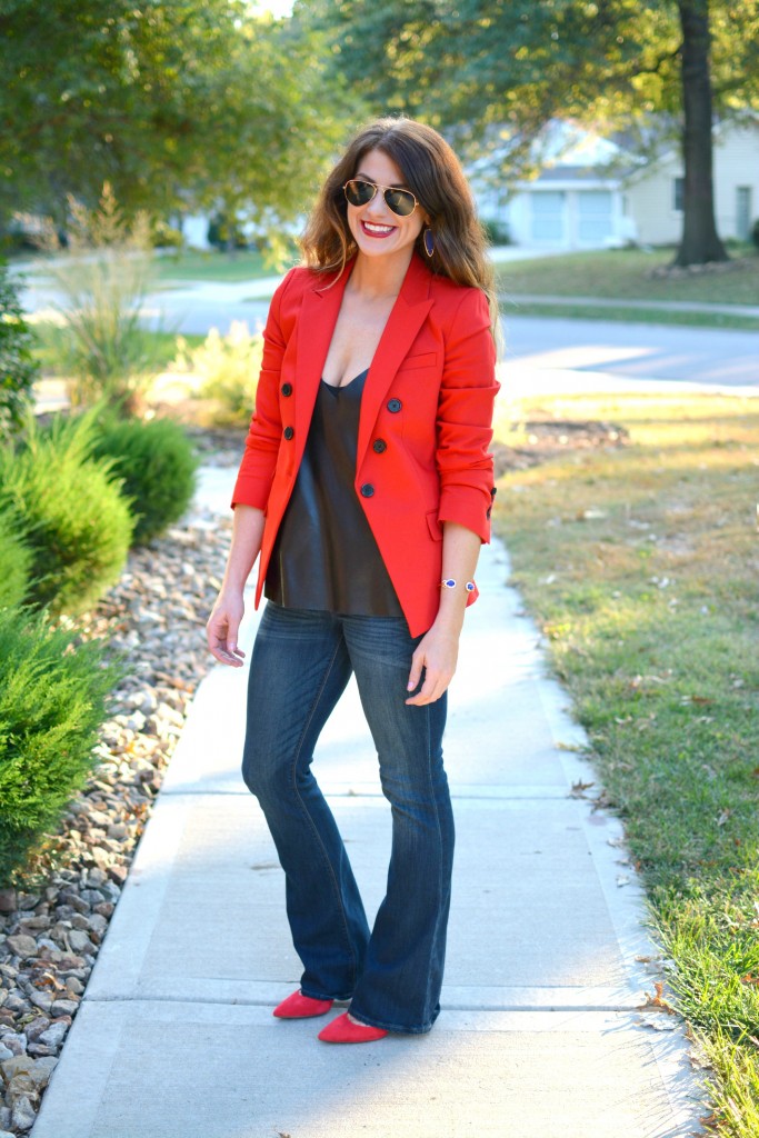 Ashley from LSR in a fire engine red blazer, flares, a leather camisole, and Kendra Scott jewelry.