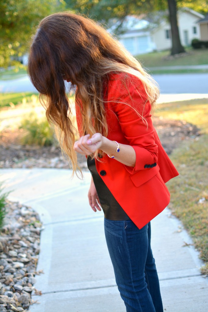 Ashley from LSR in a fire engine red blazer, flares, a leather camisole, and Kendra Scott jewelry.