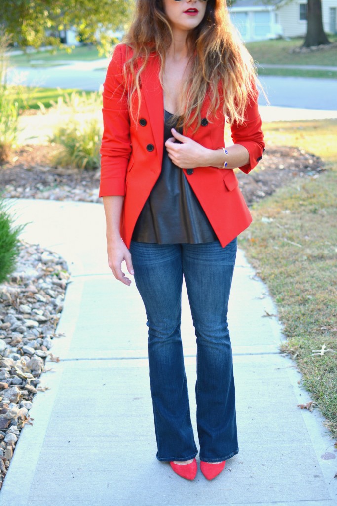 Ashley from LSR in a fire engine red blazer, flares, a leather camisole, and Kendra Scott jewelry.