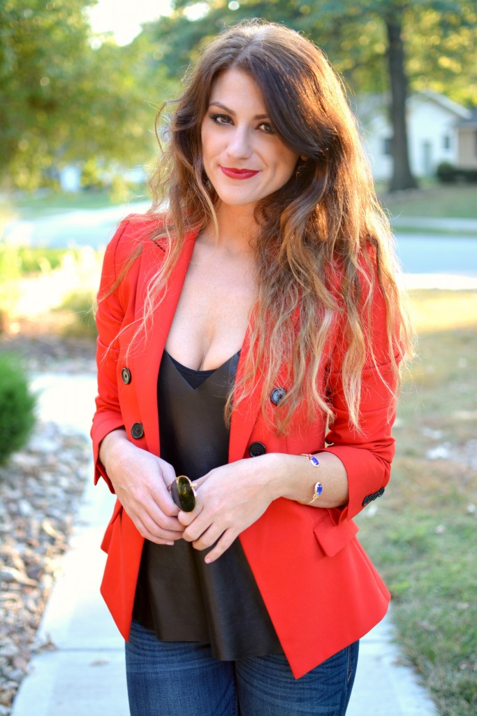 Ashley from LSR in a fire engine red blazer, flares, a leather camisole, and Kendra Scott jewelry.