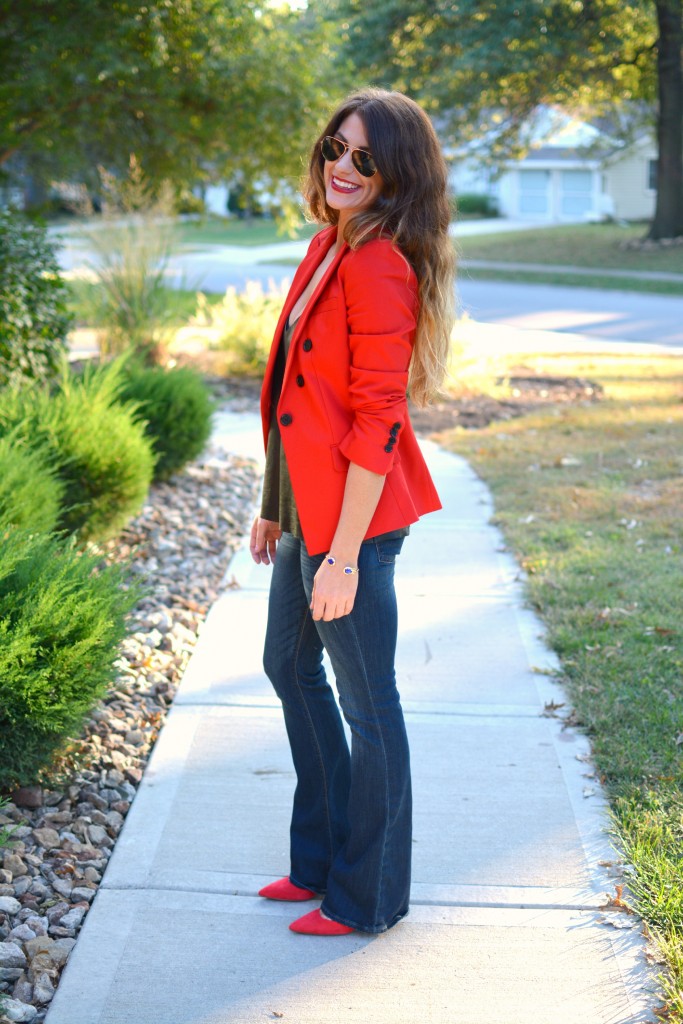 Ashley from LSR in a fire engine red blazer, flares, a leather camisole, and Kendra Scott jewelry.