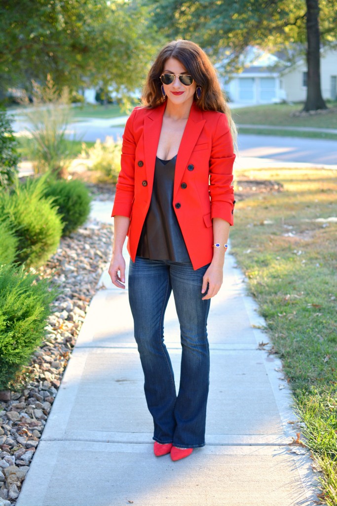 Ashley from LSR in a fire engine red blazer, flares, a leather camisole, and Kendra Scott jewelry.