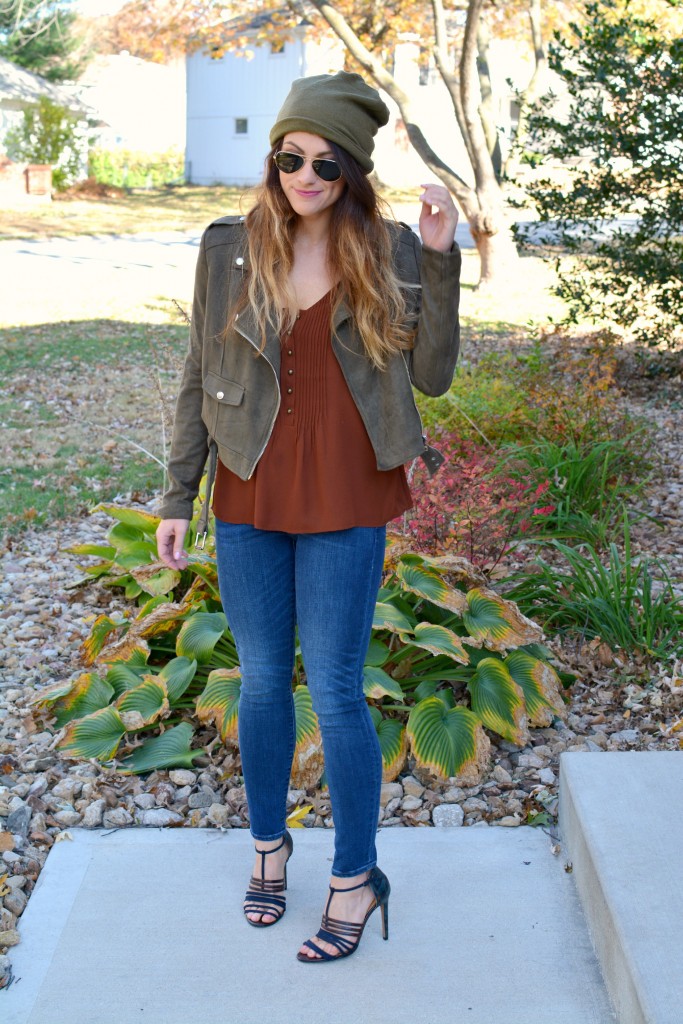 Ashley from LSR in an olive green beanie, olive green suede motorcycle jacket, an Express tank, and Gap jeans.