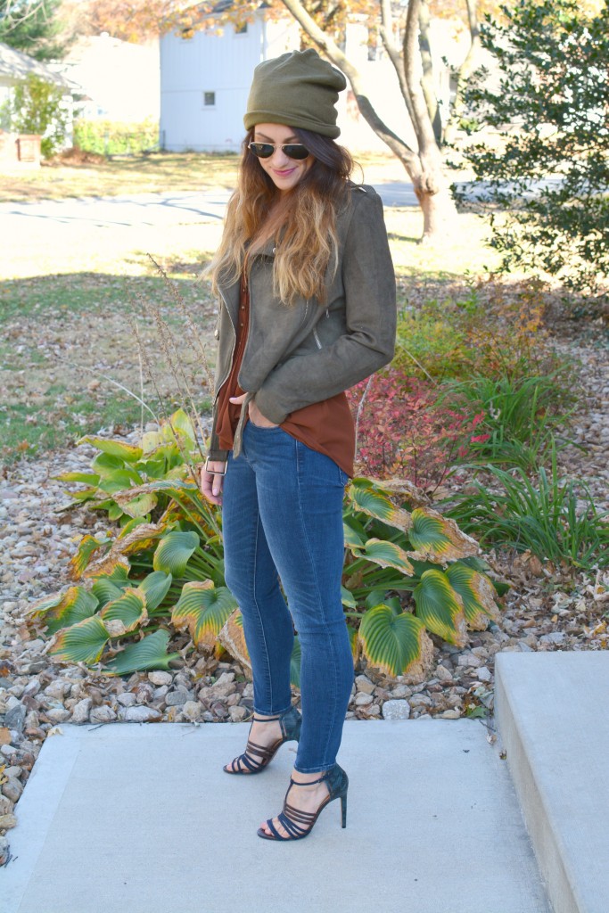 Ashley from LSR in an olive green beanie, olive green suede motorcycle jacket, an Express tank, and Gap jeans.