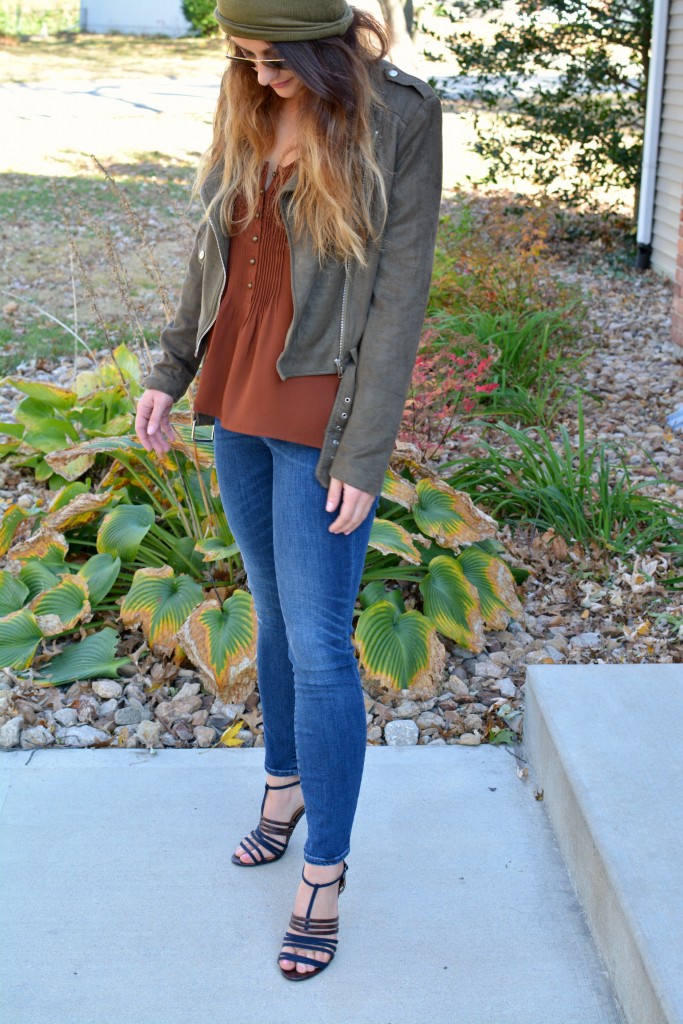 Ashley from LSR in an olive green beanie, olive green suede motorcycle jacket, an Express tank, and Gap jeans.