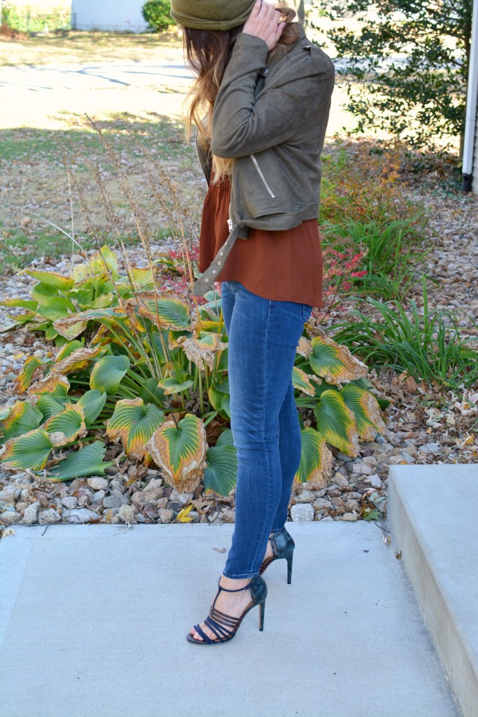 Ashley from LSR in an olive green beanie, olive green suede motorcycle jacket, an Express tank, and Gap jeans.