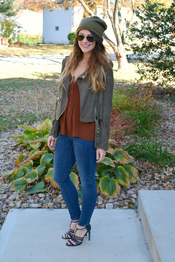 Ashley from LSR in an olive green beanie, olive green suede motorcycle jacket, an Express tank, and Gap jeans.