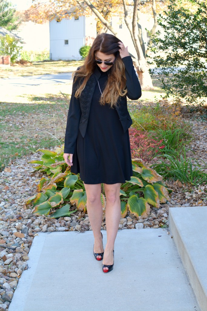 Ashley from LSR in a black turtleneck dress, black jacket, and Christian Louboutin pumps.