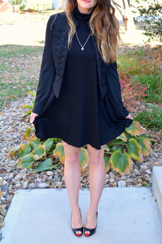 Ashley from LSR in a black turtleneck dress, black jacket, and Christian Louboutin pumps.