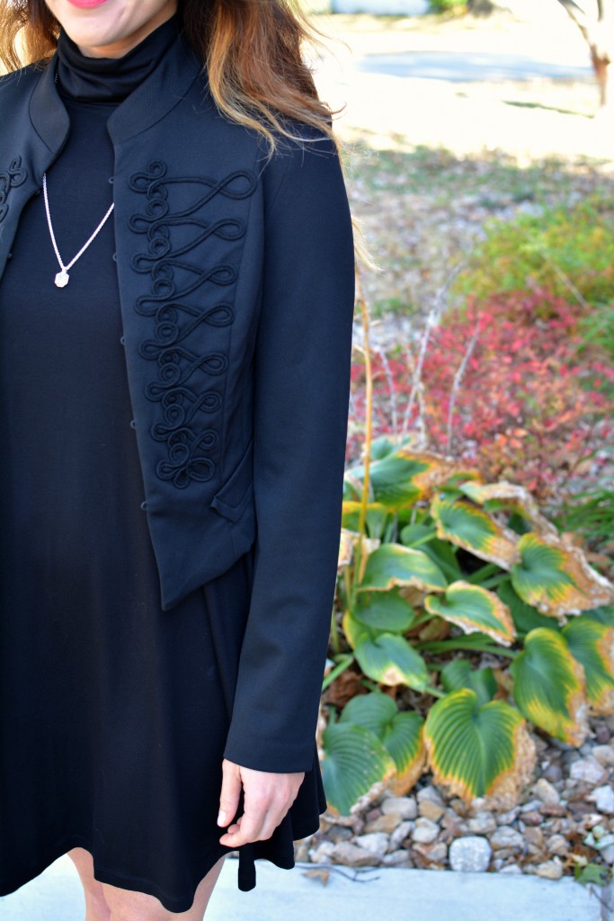 Ashley from LSR in a black turtleneck dress, black jacket, and Kendra Scott necklace.
