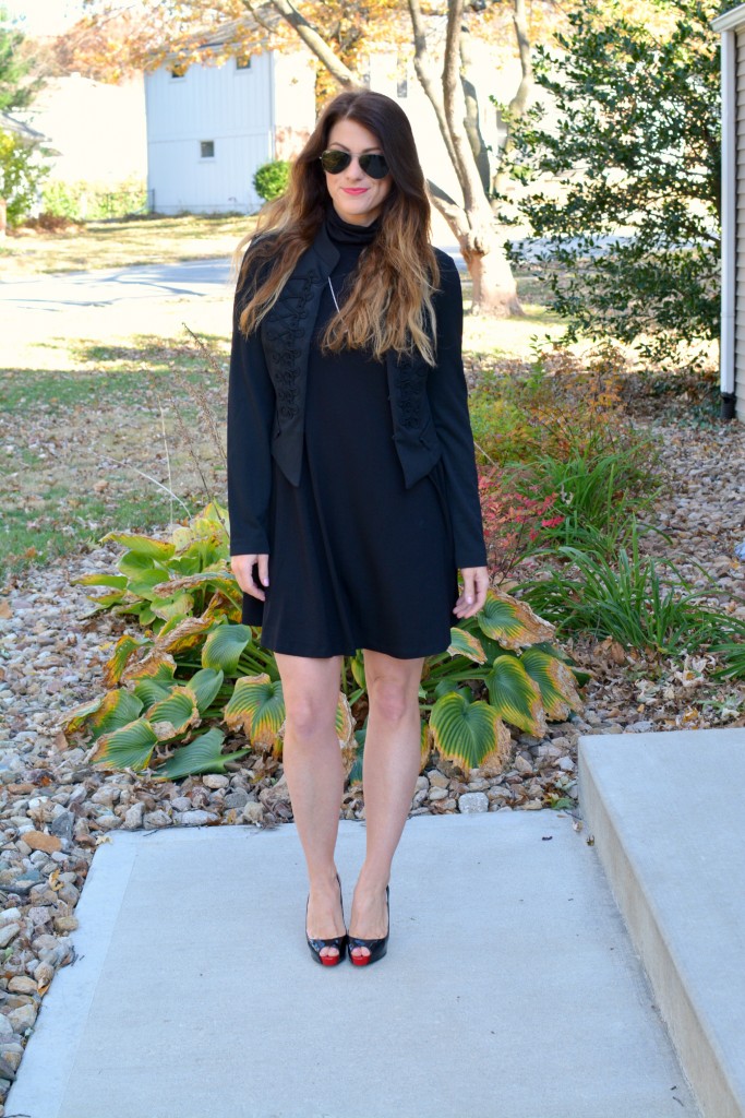 Ashley from LSR in a black turtleneck dress, black jacket, and Christian Louboutin pumps.