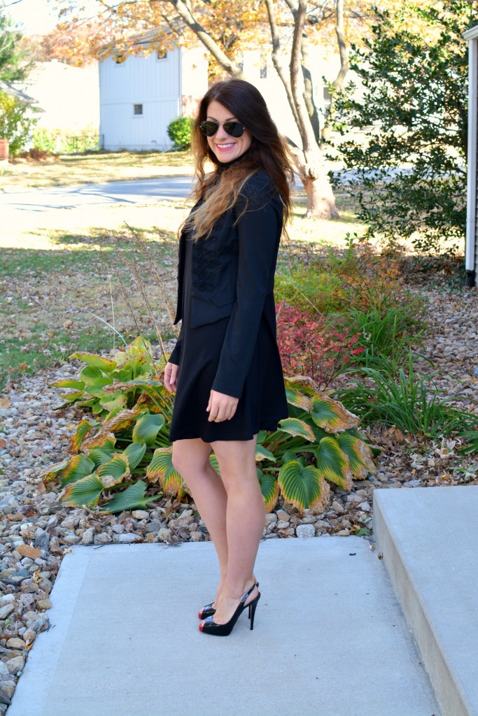 Ashley from LSR in a black turtleneck dress, black jacket, and Christian Louboutin pumps.