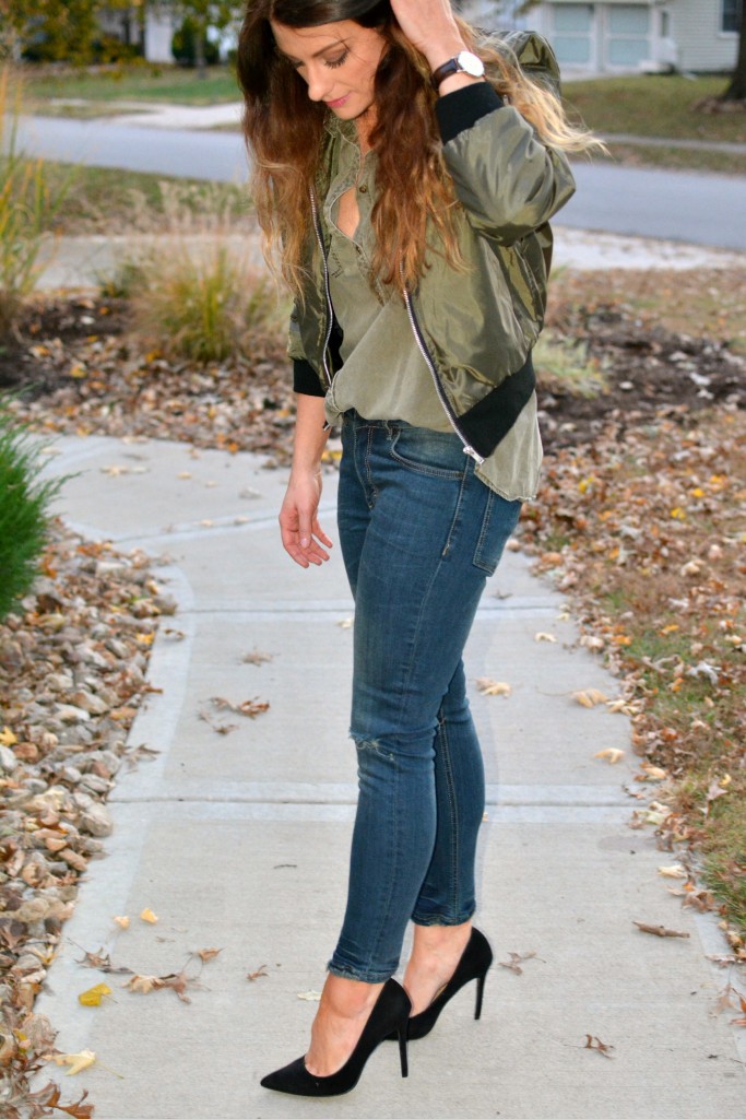 Ashley from LSR in an olive green bomber jacket, Sincerely Jules jeans, and black pumps.