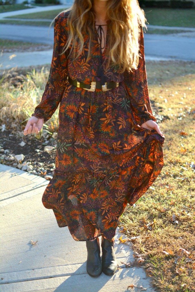 Ashley from LSR in an H&M floral maxi dress, double buckle western belt, and black flat boots.