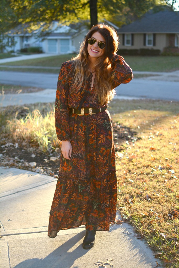 Ashley from LSR in an H&M floral maxi dress, double buckle western belt, and black flat boots.