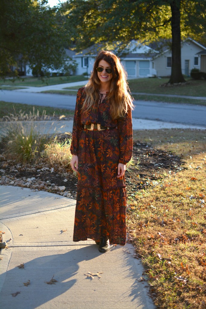 Ashley from LSR in an H&M floral maxi dress, double buckle western belt, and black flat boots.