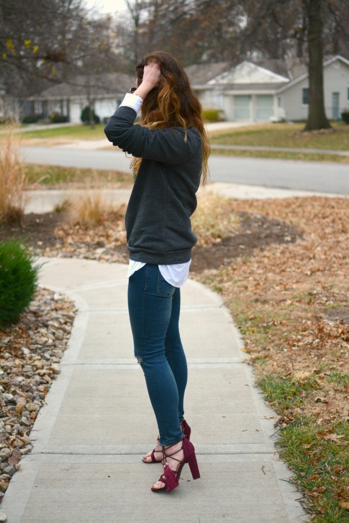 Ashley from LSR in a LocalE sweatshirt, Sincerely Jules jeans, and burgundy suede tassel sandals