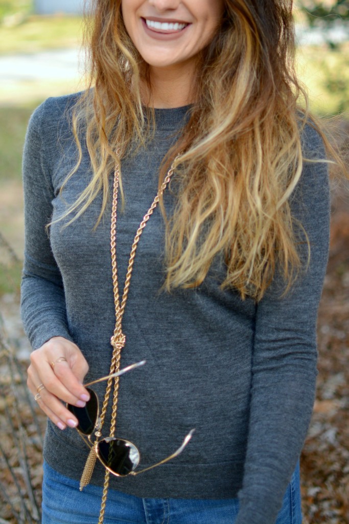 Ashley from LSR in a gray sweater and BaubleBar lariat necklace