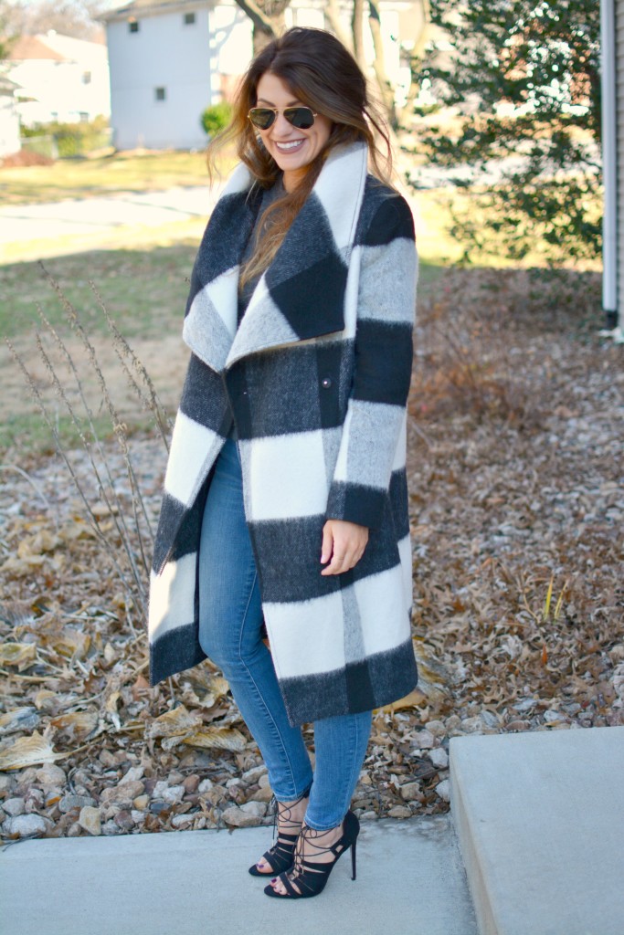 Ashley from LSR in a plaid statement coat, Gap jeans, and black lace-up sandals