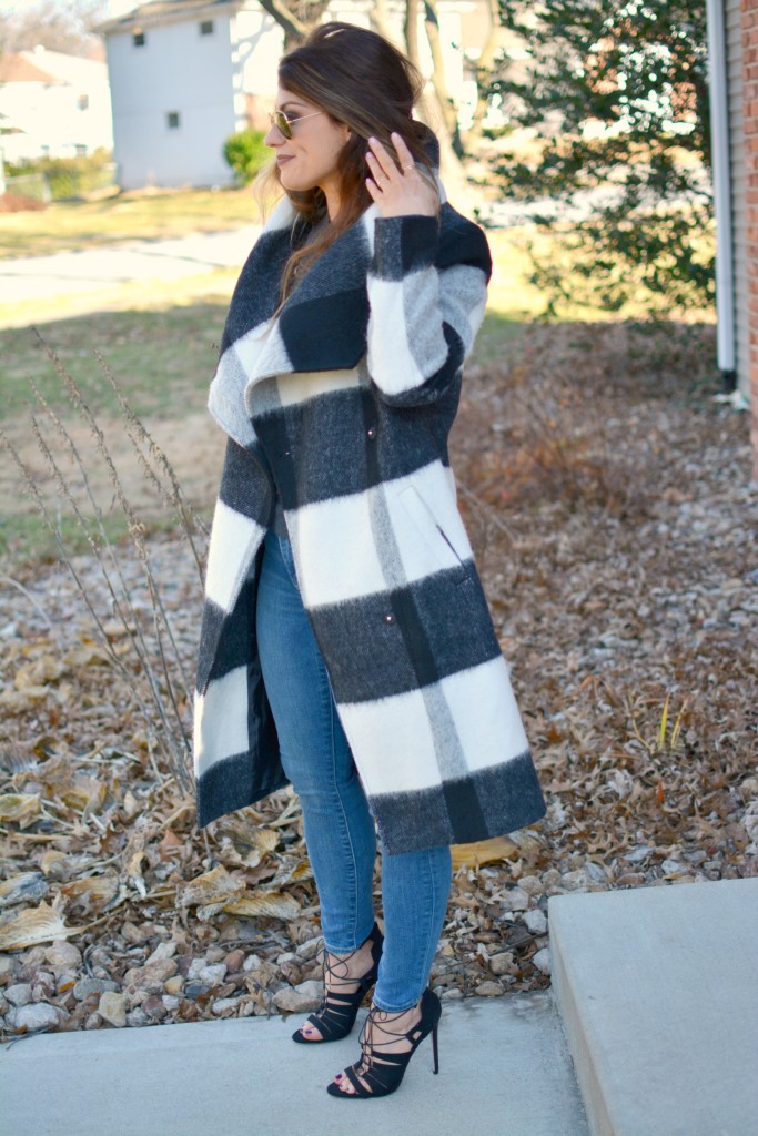 Ashley from LSR in a plaid statement coat, Gap jeans, and black lace-up sandals