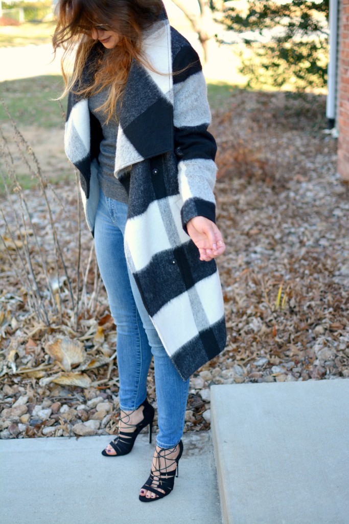 Ashley from LSR in a plaid statement coat, Gap jeans, and black lace-up sandals