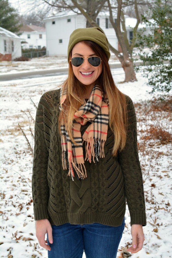 Ashley from LSR in an olive sweater, a beanie, and a Burberry scarf