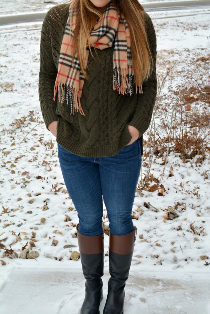 Ashley from LSR in an olive sweater, two-tone riding boots, and a Burberry scarf