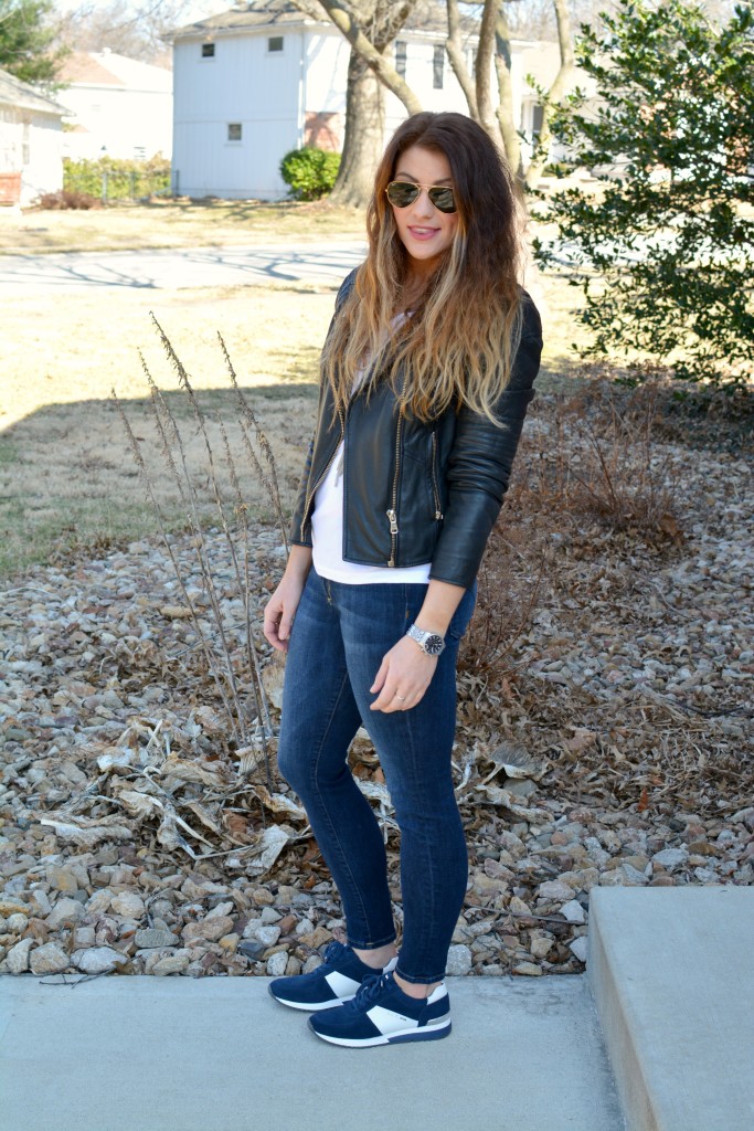 Ashley from LSR in a leather biker jacket and Michael Michael Kors Allie sneakers