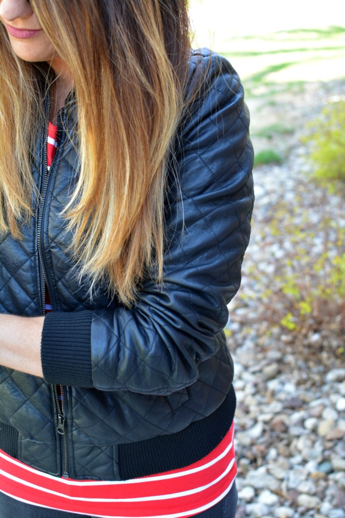 Ashley from LSR in a quilted leather jacket and a red stripe t-shirt