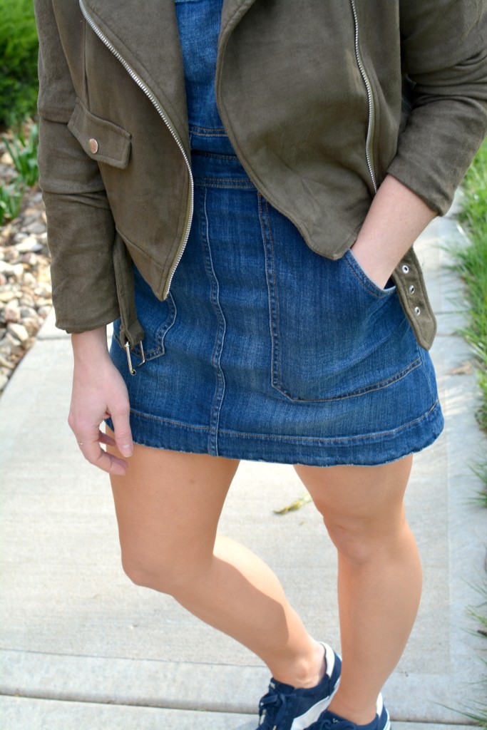 Ashley from LSR in an overall dress, suede jacket, and retro sneakers