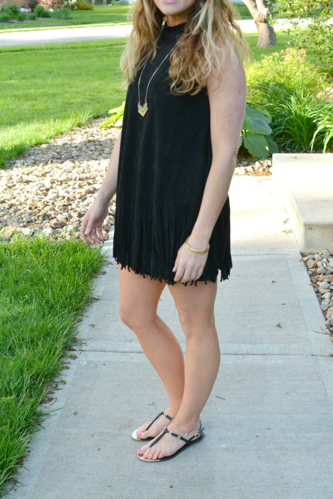 Ashley from LSR wearing a black suede fringe dress and black sandals