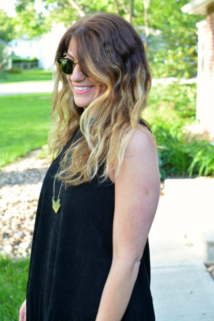 Ashley from LSR wearing a black suede fringe dress and a Madewell arrowstack necklace