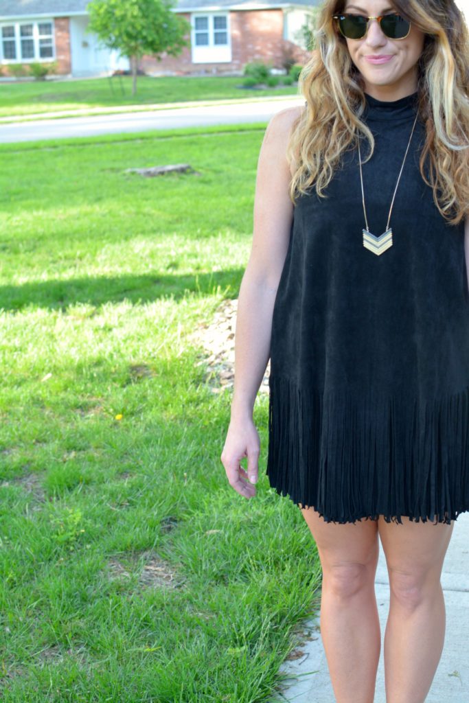 Ashley from LSR wearing a black suede fringe dress and a Madewell arrowstack necklace