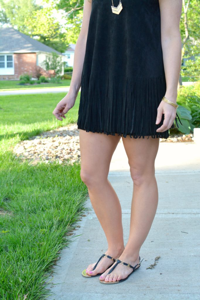 Ashley from LSR wearing a black suede fringe dress and black sandals