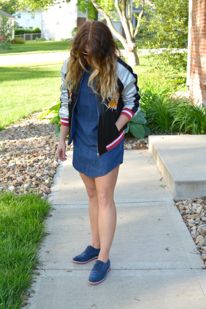 Ashley from LSR in a denim dress and silk souvenir bomber jacket