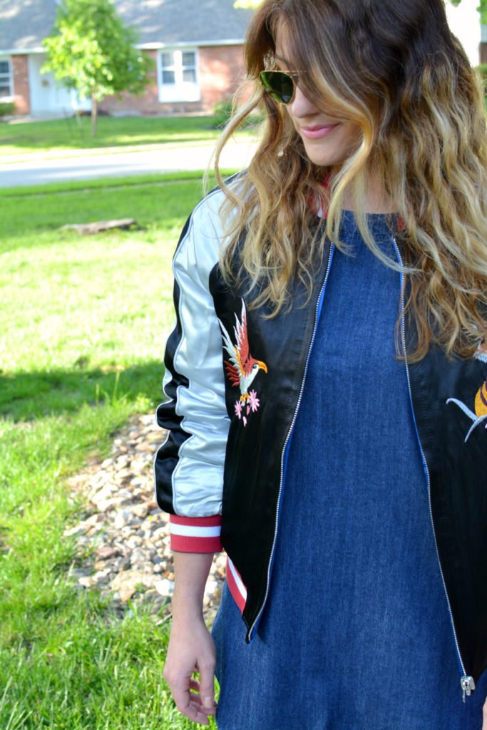 Ashley from LSR in a denim dress and silk souvenir bomber jacket